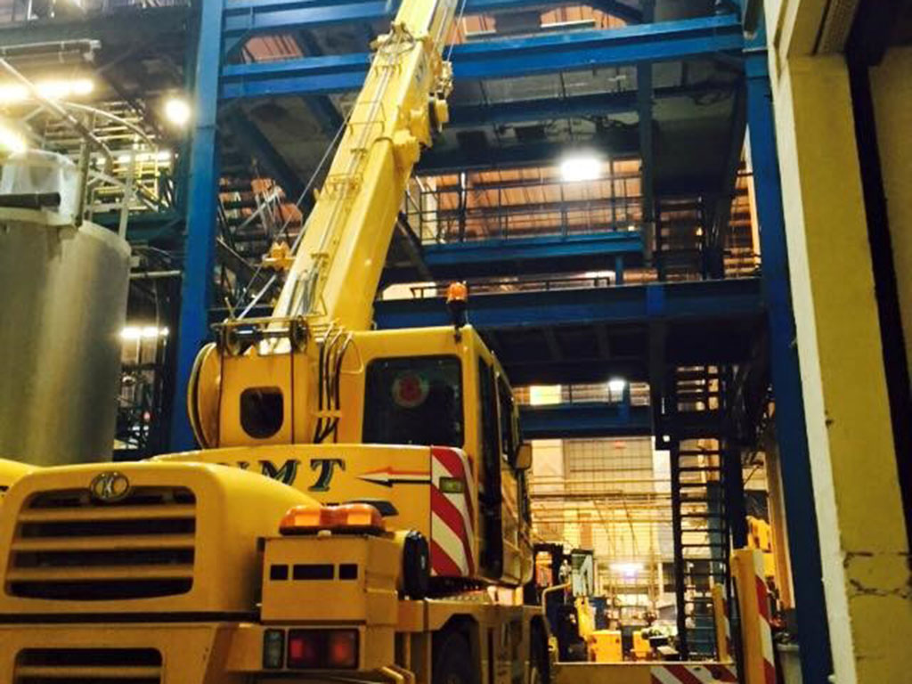 Image of a crane lifting heavy equipment